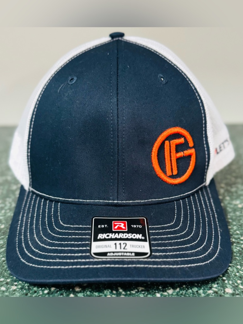 Richardson Navy & White Trucker Hat with Orange Finance Company Logo